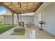 View of the back porch with chairs, table, grill, and wooden flooring at 200 Harvell Dr, Bowdon, GA 30108