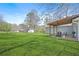 Wide shot of the backyard featuring a well-maintained lawn, a back porch and a fenced-in dog run at 200 Harvell Dr, Bowdon, GA 30108