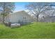 Exterior view of the home with lush green grass and a fenced yard for added privacy at 200 Harvell Dr, Bowdon, GA 30108