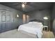 A bedroom featuring dark walls and a white ceiling fan, with a bed and a closet at 200 Harvell Dr, Bowdon, GA 30108