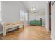Bright dining area featuring wood floors, neutral bench seating, and open shelving at 200 Harvell Dr, Bowdon, GA 30108