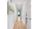 Hallway with hardwood flooring and white wainscotting, leading to rooms with neutral paint and decor at 200 Harvell Dr, Bowdon, GA 30108