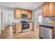 A kitchen featuring wooden cabinets, stainless steel appliances, and light countertops and flooring at 200 Harvell Dr, Bowdon, GA 30108