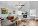 Cozy living room with white brick fireplace, wood floors, and natural light at 200 Harvell Dr, Bowdon, GA 30108