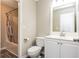 Full bathroom with a vinyl floor, vanity, toilet, and shower-tub combo at 407 Red Coat Ln, Woodstock, GA 30188
