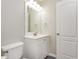 Bathroom with a white vanity, stylish lighting and an arched-top door at 407 Red Coat Ln, Woodstock, GA 30188