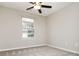 Simple bedroom with neutral walls, carpet, ceiling fan, and window at 407 Red Coat Ln, Woodstock, GA 30188