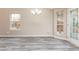 Bright dining area featuring a modern chandelier and lots of sunlight at 407 Red Coat Ln, Woodstock, GA 30188