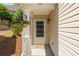 Cozy front entrance with a decorative hanging plant and 'hello' door mat at 407 Red Coat Ln, Woodstock, GA 30188
