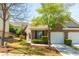 Charming brick home with a well-manicured lawn and attached one car garage at 407 Red Coat Ln, Woodstock, GA 30188