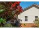 Siding exterior accented by a lovely Japanese Maple, and lush landscaping at 407 Red Coat Ln, Woodstock, GA 30188
