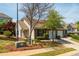 Inviting home with well-maintained landscaping, garage, and sidewalk to front door at 407 Red Coat Ln, Woodstock, GA 30188