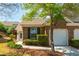 Charming brick home with a well-manicured lawn and attached one car garage at 407 Red Coat Ln, Woodstock, GA 30188