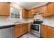 Well-lit kitchen boasting stainless steel appliances and oak cabinets at 407 Red Coat Ln, Woodstock, GA 30188