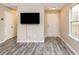 Bright living room featuring hardwood floors, ceiling fan, and a tv at 407 Red Coat Ln, Woodstock, GA 30188