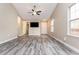 Bright living room featuring hardwood floors and a ceiling fan at 407 Red Coat Ln, Woodstock, GA 30188