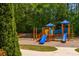 Community playground with slides and climbing structures for children at 407 Red Coat Ln, Woodstock, GA 30188