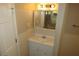 Bathroom featuring a sink with cabinets, mirror and sconces at 490 Culberson Sw St, Atlanta, GA 30310
