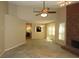 Spacious living room with a brick fireplace, large windows, and ceiling fan at 490 Culberson Sw St, Atlanta, GA 30310