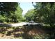 Street with dense tree coverage creating a park-like setting with some trash at 490 Culberson Sw St, Atlanta, GA 30310