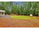 Extensive backyard featuring mature trees, a swing set, and a storage shed at 11540 Northgate Way, Roswell, GA 30075