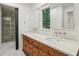 Bright bathroom featuring a double vanity with a marble countertop and walk in shower at 11540 Northgate Way, Roswell, GA 30075