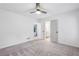 Spacious bedroom with plush carpet, neutral colors, a ceiling fan and an en suite bathroom at 11540 Northgate Way, Roswell, GA 30075
