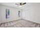 Bright bedroom with neutral carpet, two windows, and a closet at 11540 Northgate Way, Roswell, GA 30075