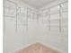 Walk in closet featuring white walls and carpeted flooring with ample shelving at 11540 Northgate Way, Roswell, GA 30075
