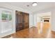 Bright entryway featuring hardwood floors, large wood doors, and an open view to the living room with fireplace at 11540 Northgate Way, Roswell, GA 30075