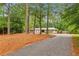 Scenic view of home with long driveway, landscaping, and mature trees at 11540 Northgate Way, Roswell, GA 30075