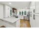 New kitchen featuring stainless steel appliances, a large island, plenty of cabinet space, and hardwood floors at 11540 Northgate Way, Roswell, GA 30075