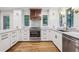 Updated kitchen with white cabinets, stainless steel appliances, and hardwood floors at 11540 Northgate Way, Roswell, GA 30075