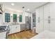 Bright modern kitchen featuring white cabinets, stainless steel appliances, and white marble countertops at 11540 Northgate Way, Roswell, GA 30075