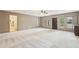 Bright living room featuring natural lighting, neutral carpet, and an open floor plan at 11540 Northgate Way, Roswell, GA 30075