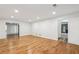 Expansive living room with hardwood floors, recessed lighting, and seamless transitions to adjacent rooms at 11540 Northgate Way, Roswell, GA 30075