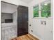 View of a room featuring natural light, dark trim, and hardwood flooring at 11540 Northgate Way, Roswell, GA 30075