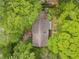 Home surrounded by mature trees, showcasing the roofline and backyard garden at 1725 Timberland Ne Rd, Atlanta, GA 30345
