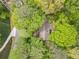 Overhead shot of a home with lush, mature trees, green lawn, and a winding driveway at 1725 Timberland Ne Rd, Atlanta, GA 30345