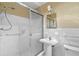 A bathroom with a glass-enclosed shower, a pedestal sink, and white tile walls at 1725 Timberland Ne Rd, Atlanta, GA 30345