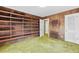 Bedroom featuring built-in shelves, textured walls, and an adjacent closet at 1725 Timberland Ne Rd, Atlanta, GA 30345
