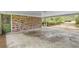 View of attached carport showing brick construction, direct access to the house, and view to front yard at 1725 Timberland Ne Rd, Atlanta, GA 30345