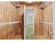 Wood-paneled walk-in closet featuring wire shelving for organization and storage at 1725 Timberland Ne Rd, Atlanta, GA 30345