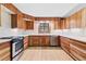 Bright kitchen featuring stainless steel appliances, wood cabinets, and natural light from the window at 1725 Timberland Ne Rd, Atlanta, GA 30345