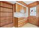 Butlers pantry area with wood cabinets and shelves, stone countertop, and decorative door at 1725 Timberland Ne Rd, Atlanta, GA 30345