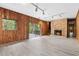 A living room with wood walls, light floors, a fireplace and sliding doors that lead to the outside at 1725 Timberland Ne Rd, Atlanta, GA 30345