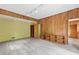Spacious living room with unique wooden walls, built-in shelving, and modern lighting fixtures at 1725 Timberland Ne Rd, Atlanta, GA 30345
