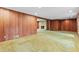Cozy living room with a fireplace, wood paneling and carpet, creating a warm and inviting atmosphere at 1725 Timberland Ne Rd, Atlanta, GA 30345