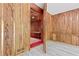 Unique room featuring wooden walls, carpeted floors, and what looks like an entrance to a vault at 1725 Timberland Ne Rd, Atlanta, GA 30345