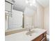 Well-lit bathroom featuring granite counters, modern fixtures, and bright vanity lights at 215 Semel Nw Dr # 455, Atlanta, GA 30309